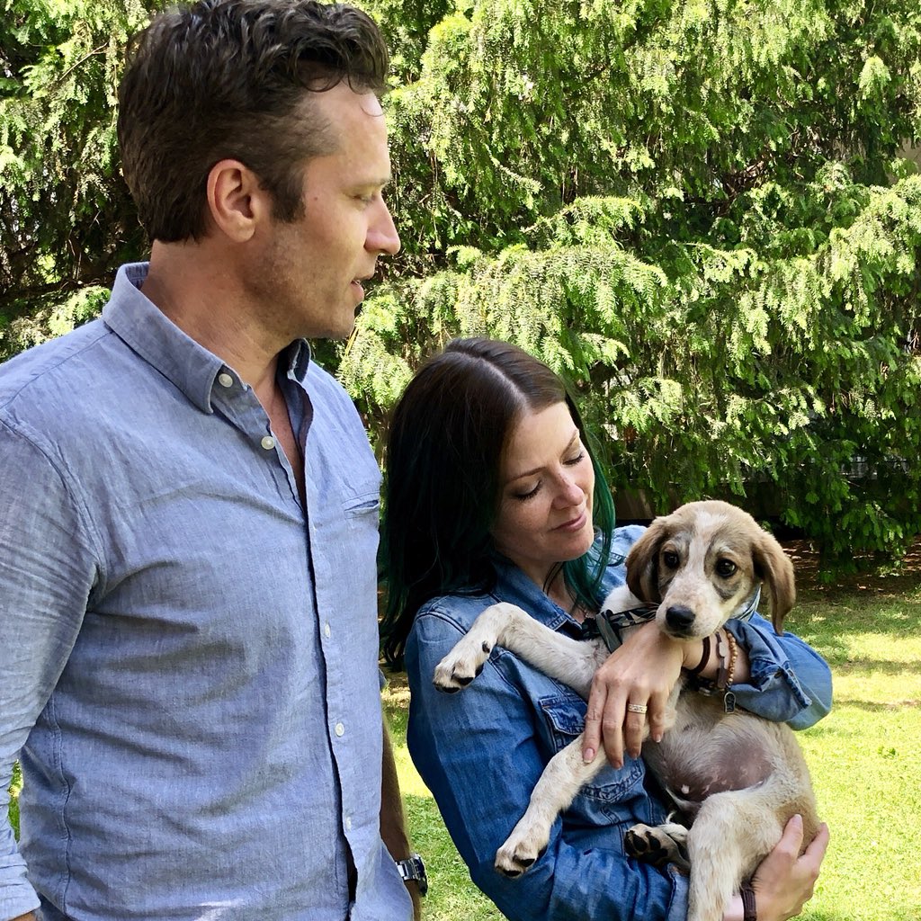 Seamus Dever and Juliana Dever showering love to their pet 